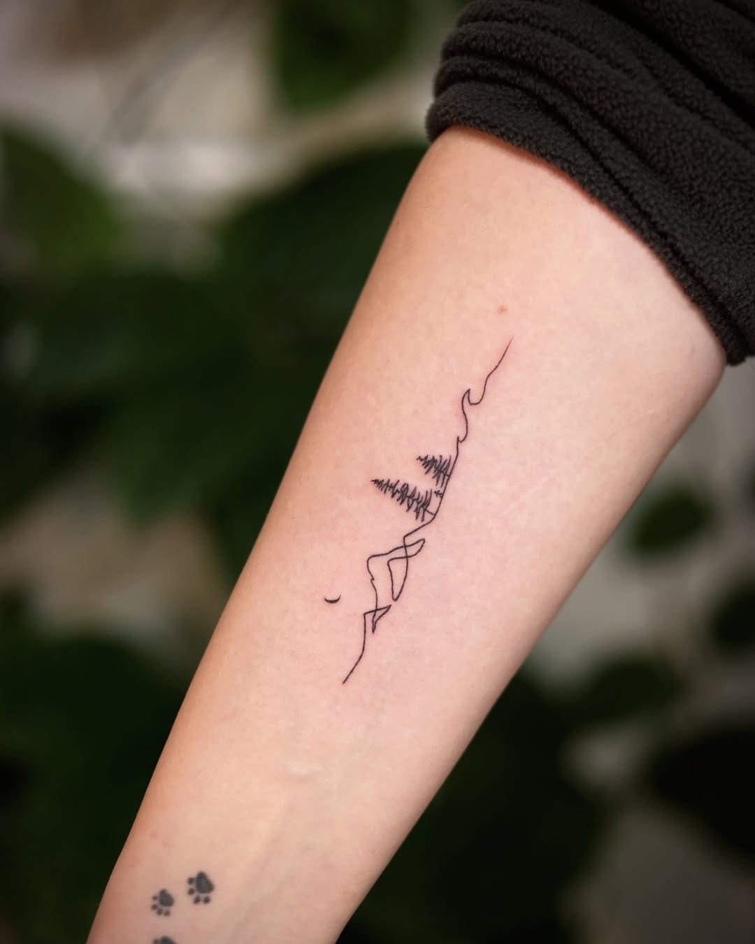 Elegant minimalist mountain line tattoo design