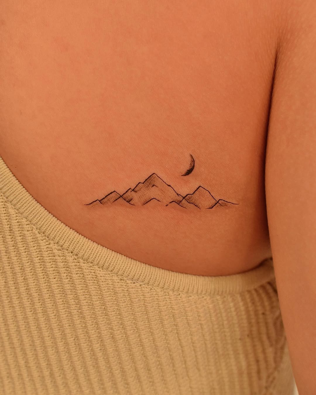 Elegant mountain tattoo with crescent moon