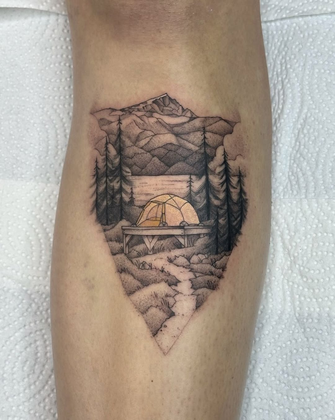 Serene mountain campsite tattoo design