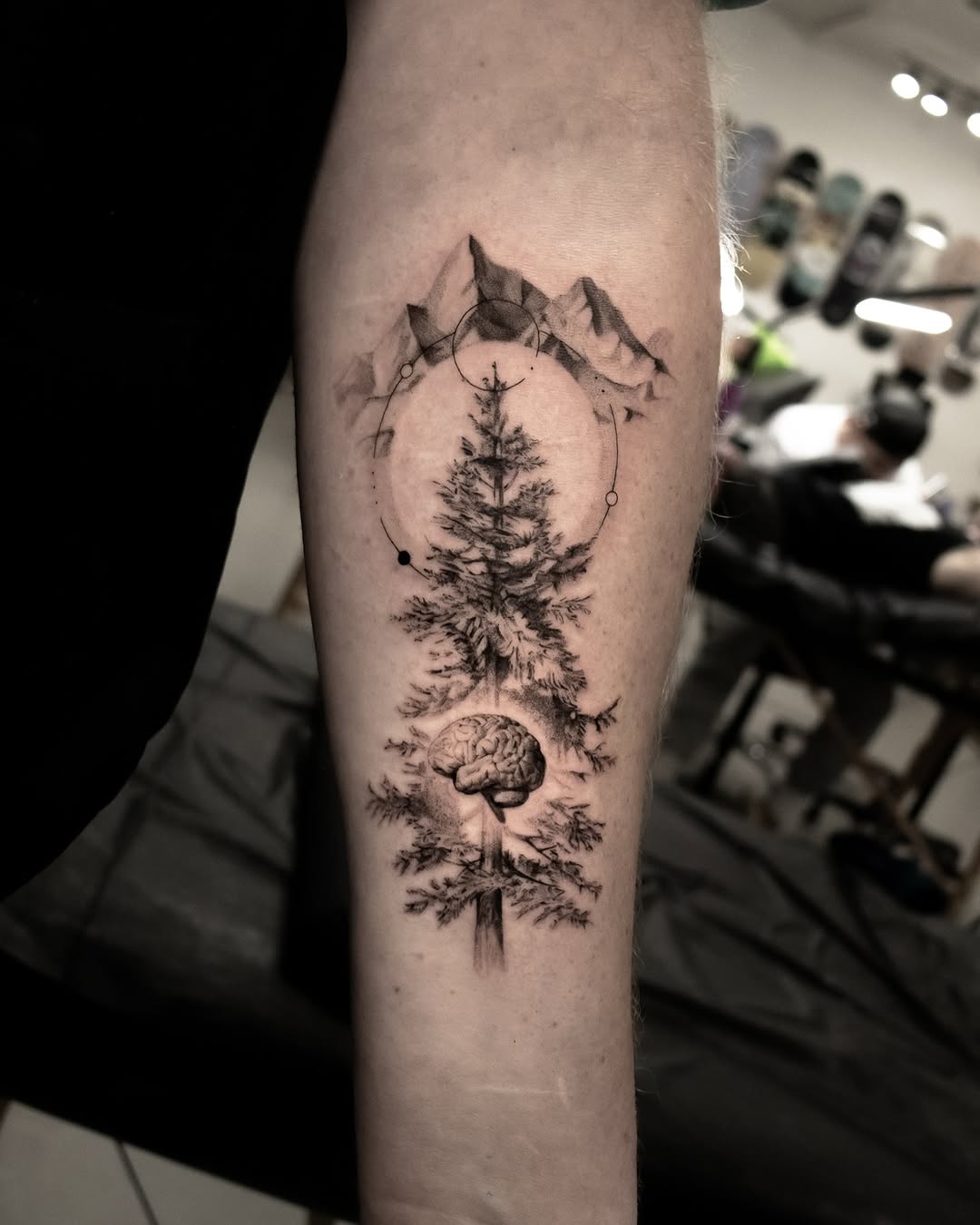 Intricate mountain and tree tattoo with brain