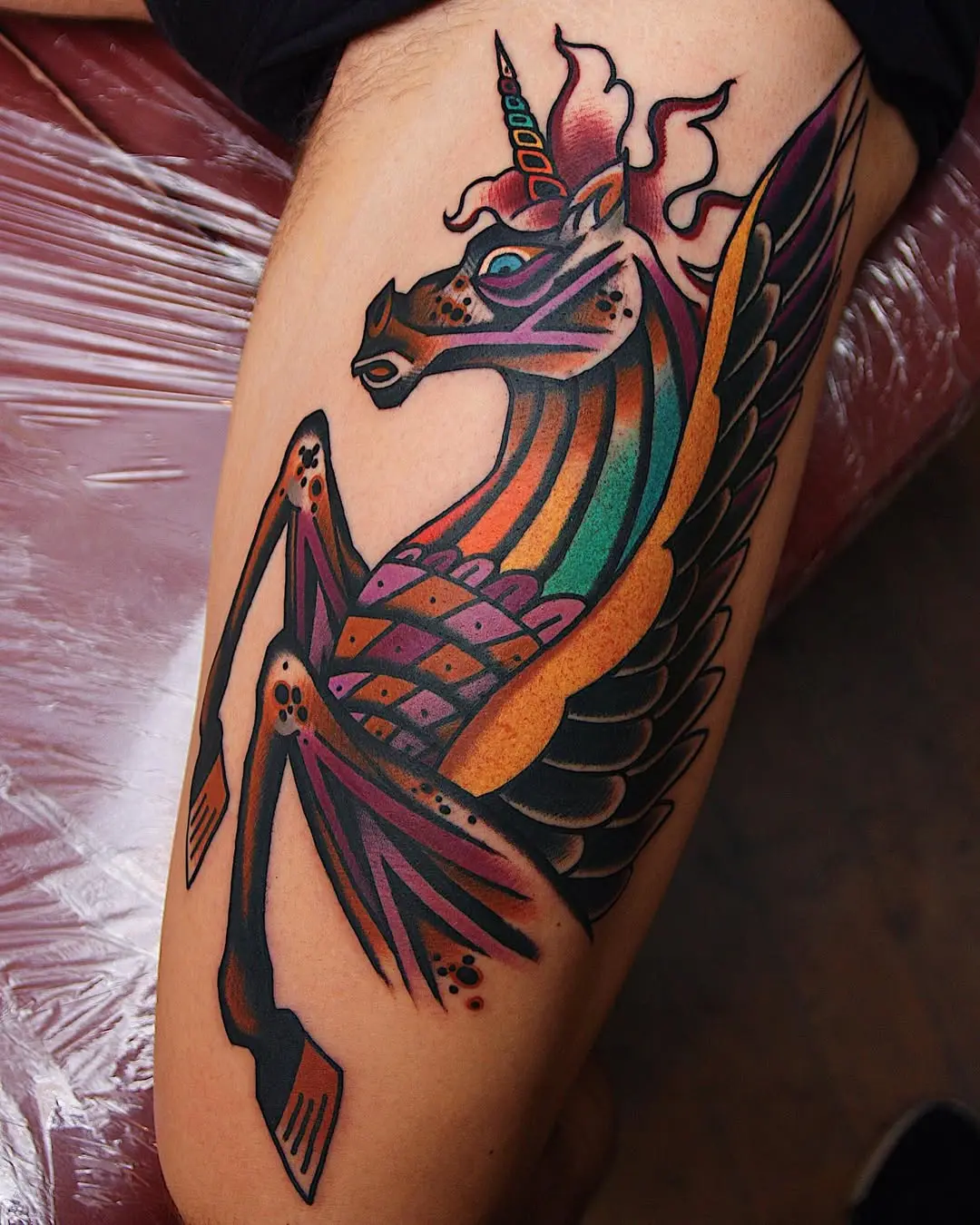 A vibrant unicorn tattoo full of fantasy.