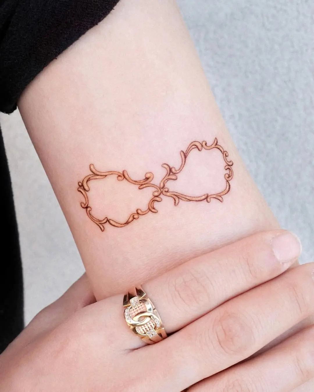 Intricate infinity tattoo with floral elements