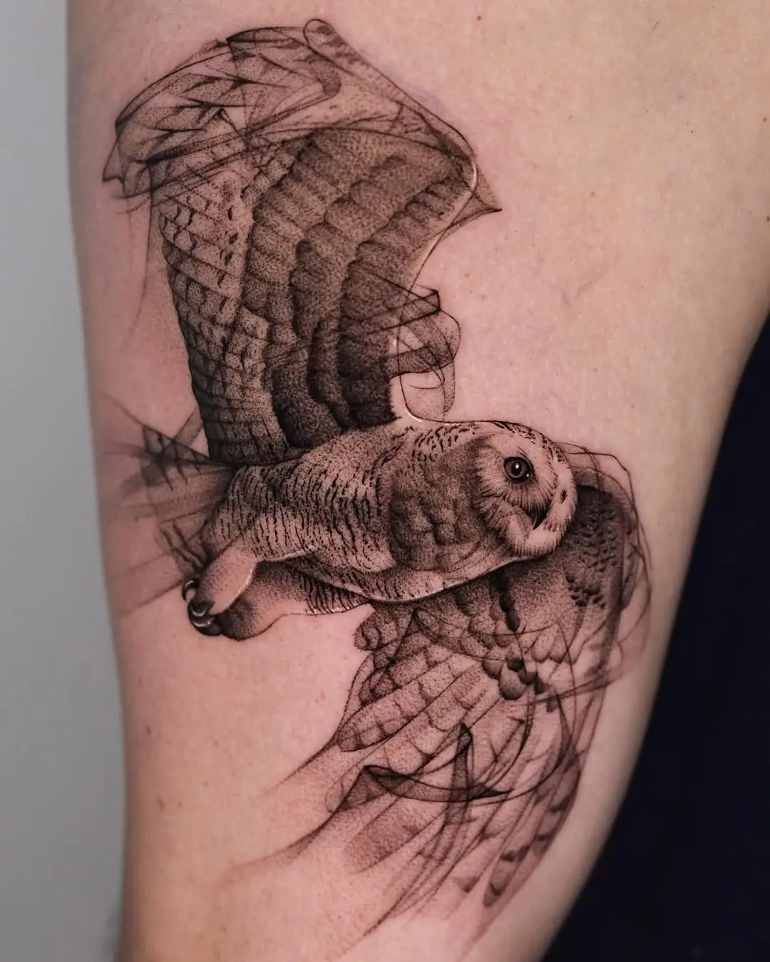 Stunning black and gray flying owl tattoo