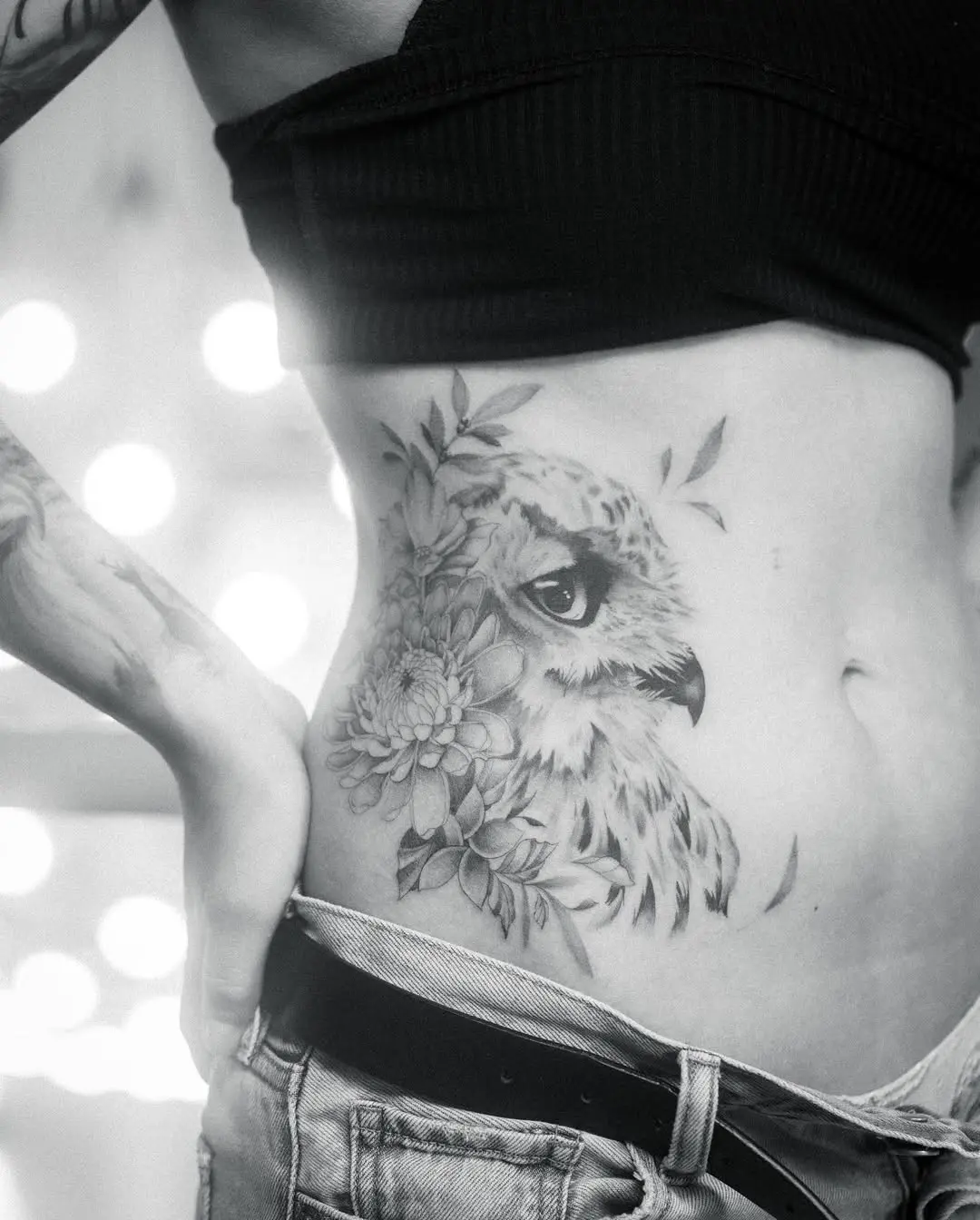 Stunning owl tattoo with floral elements