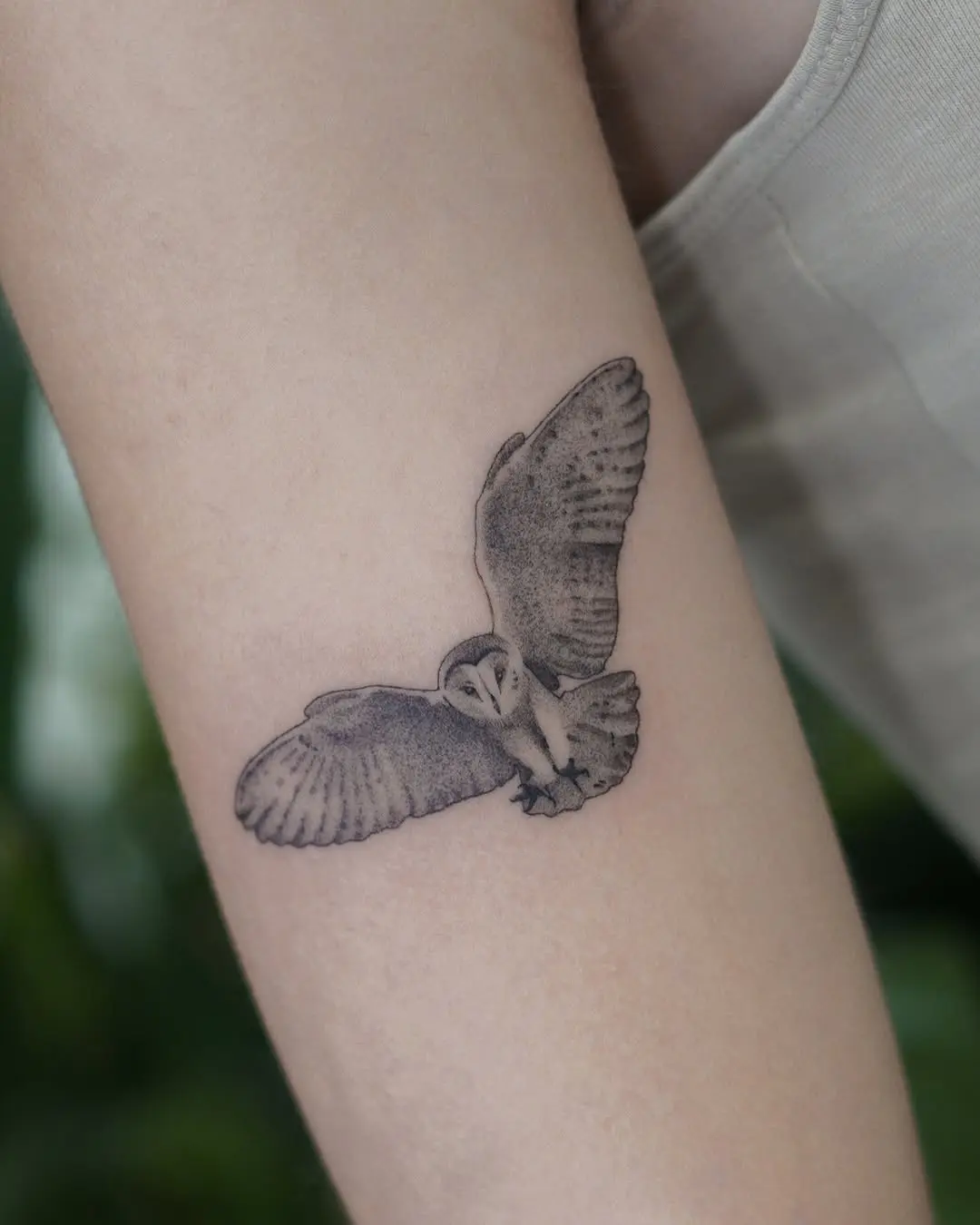 Elegant owl tattoo in flight showcases beauty