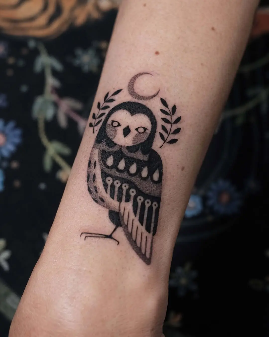 Artistic owl tattoo with crescent moon detail