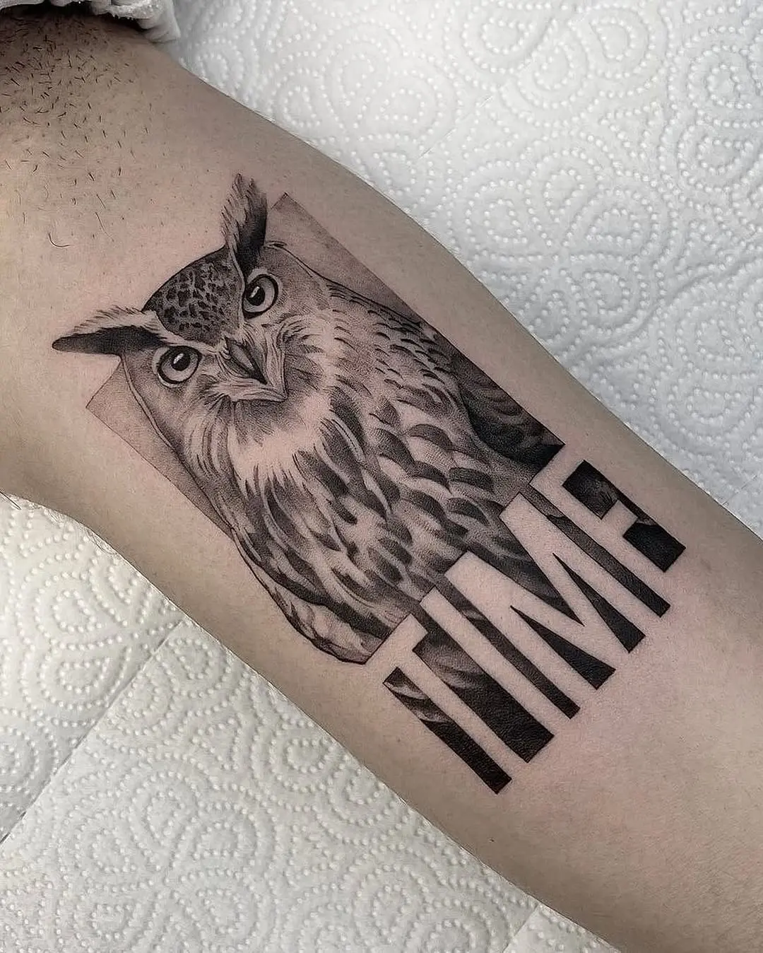 Intricate owl tattoo with a bold message