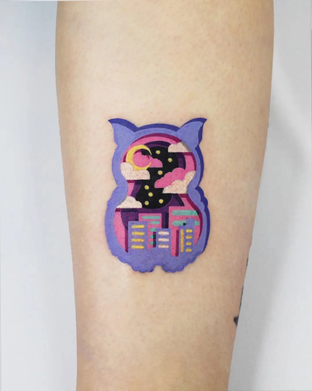 Unique owl tattoo with cityscape and night sky