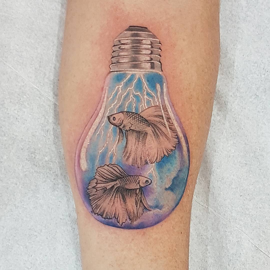 Unique lightbulb tattoo with flowing fish design