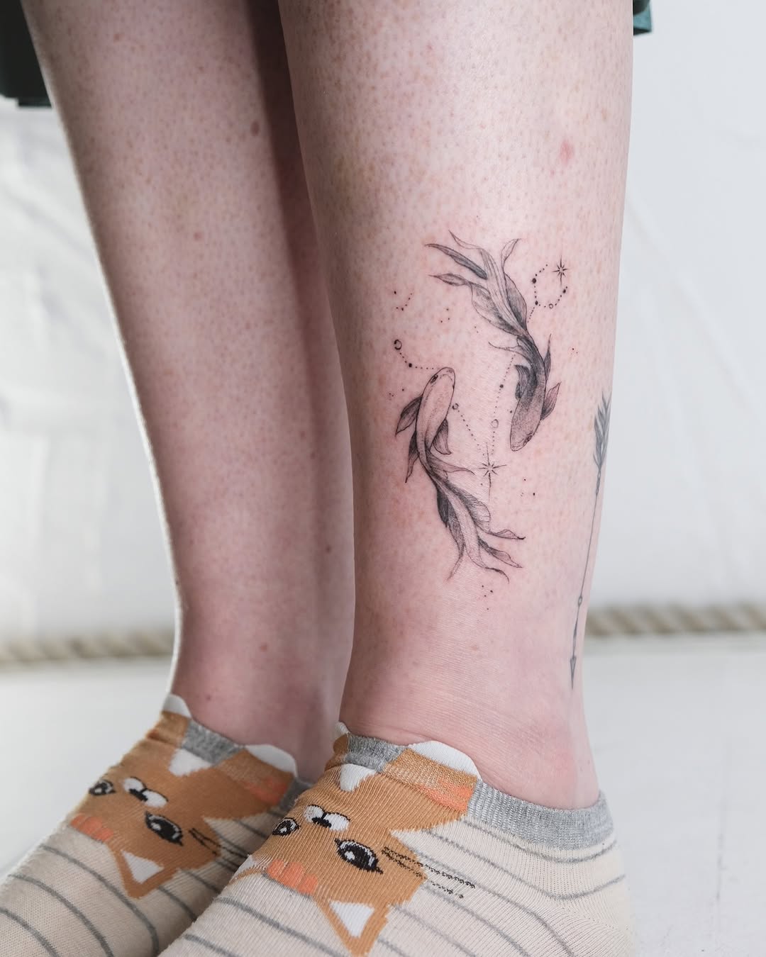 Elegant Pisces tattoos featuring paired fish design