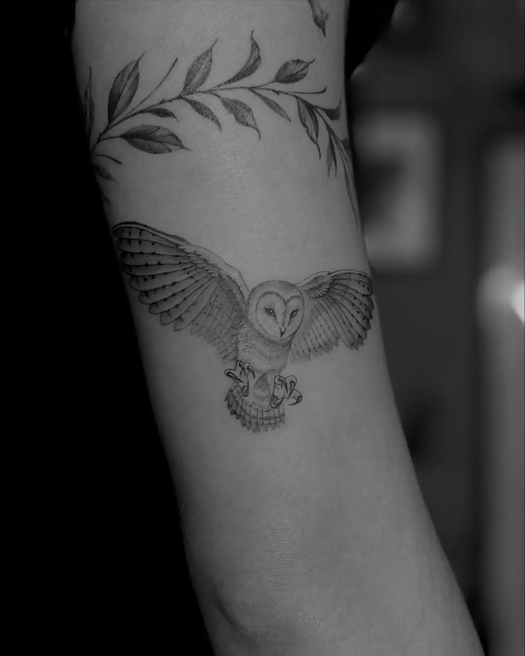 Elegant black and white owl tattoo in flight