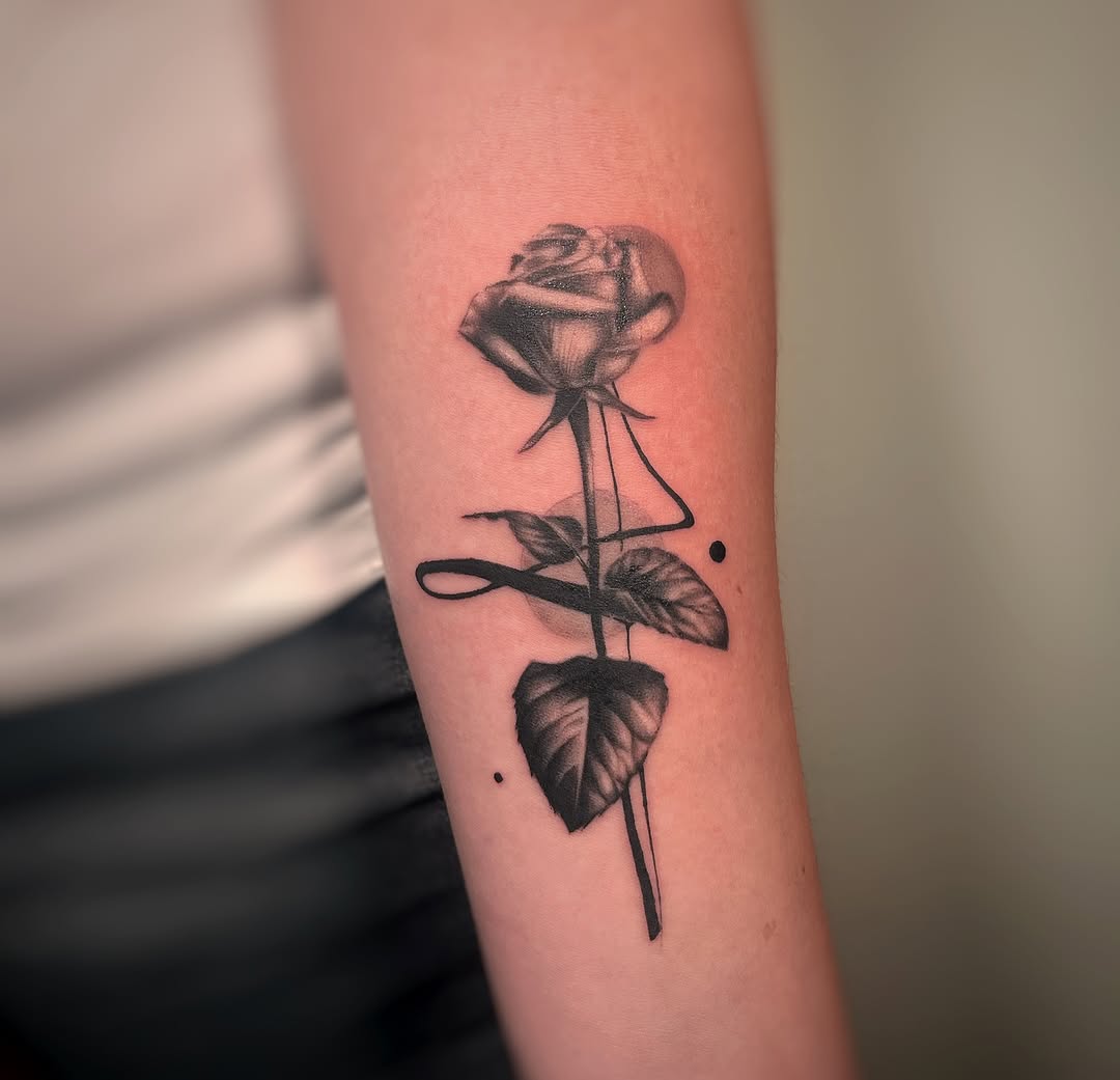 Elegant black and gray rose tattoo on forearm