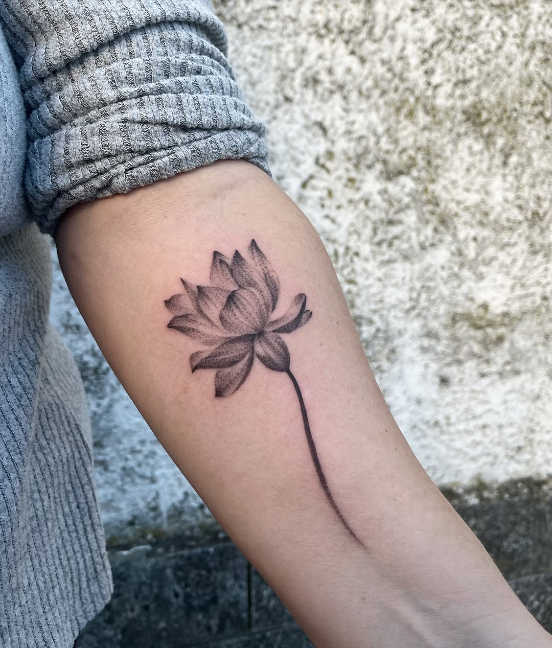 Stunning black and gray lotus flower tattoo