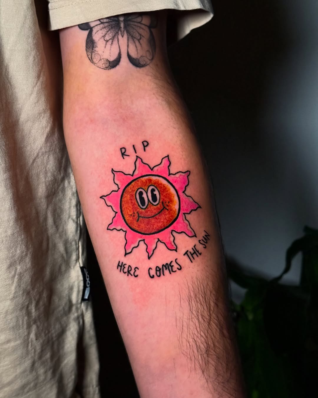 Playful sun tattoo with vibrant colors