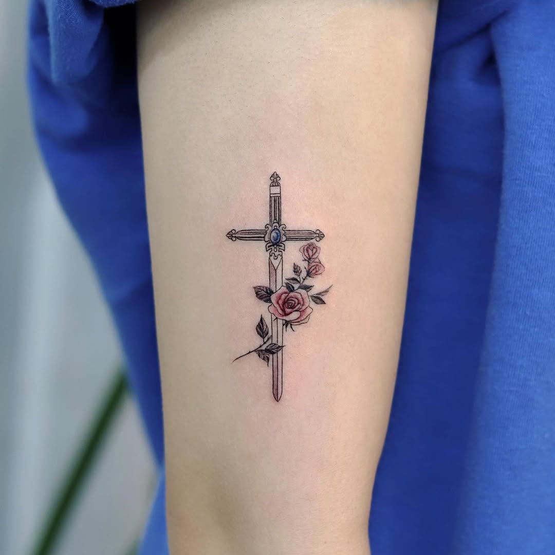 Elegant rose and cross tattoo design