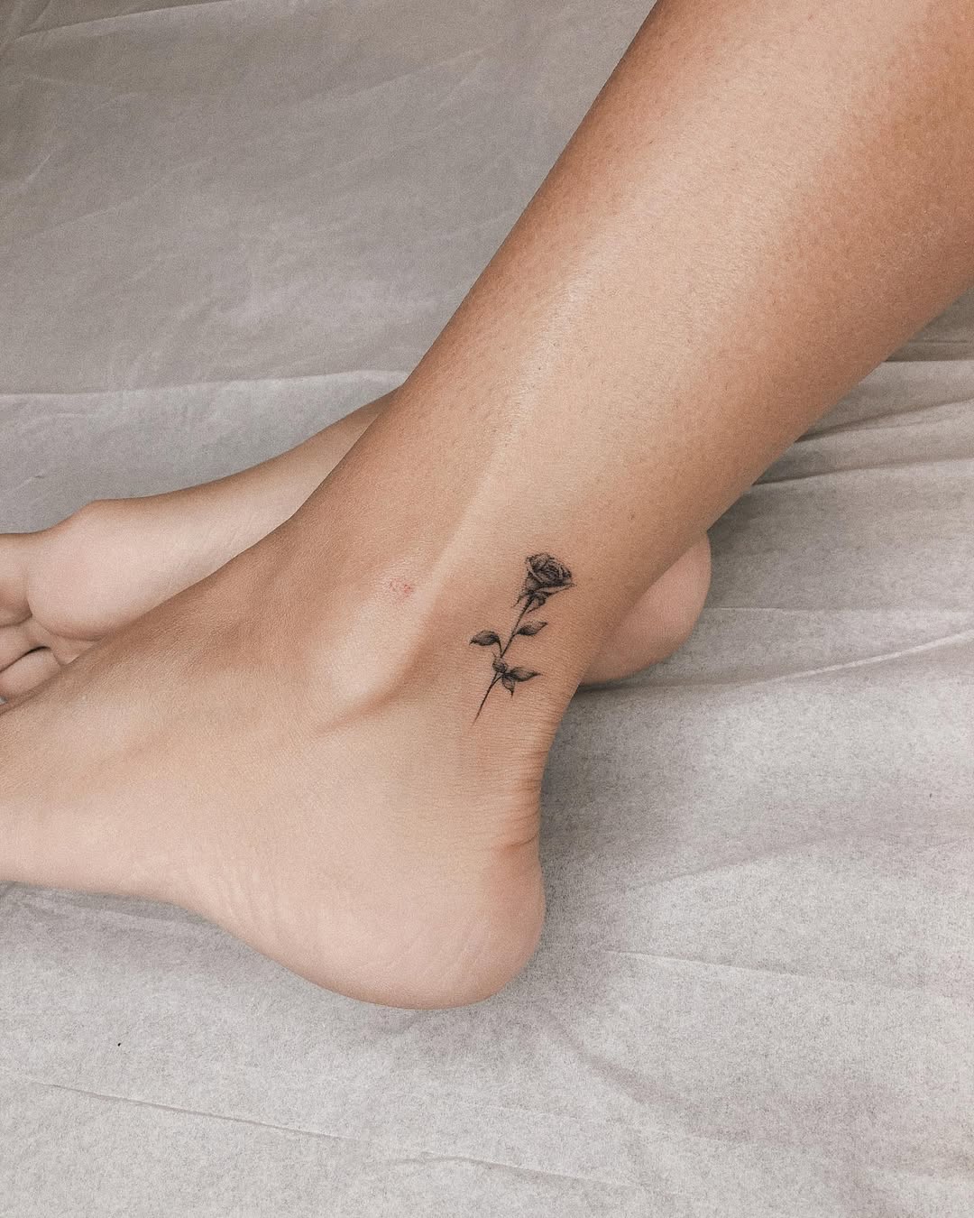 Elegant rose tattoo on ankle with minimalist design