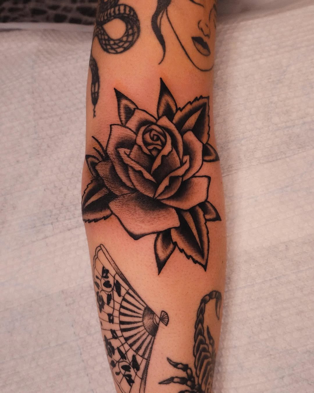 Stunning black rose tattoo on the forearm