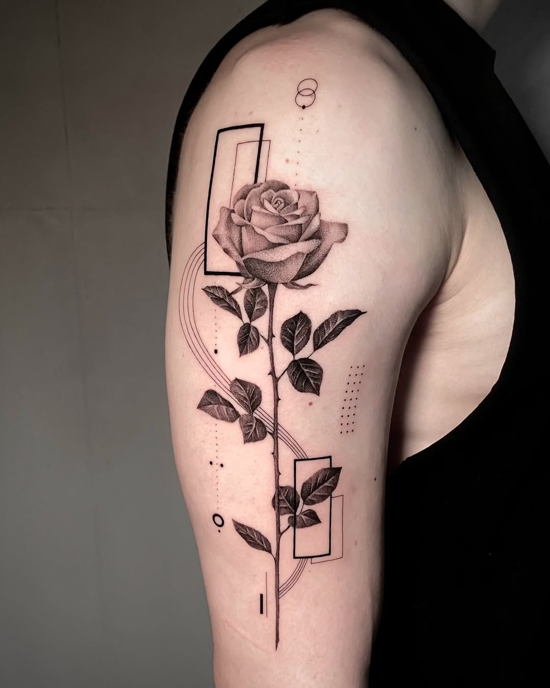 Elegant rose tattoo with geometric elements