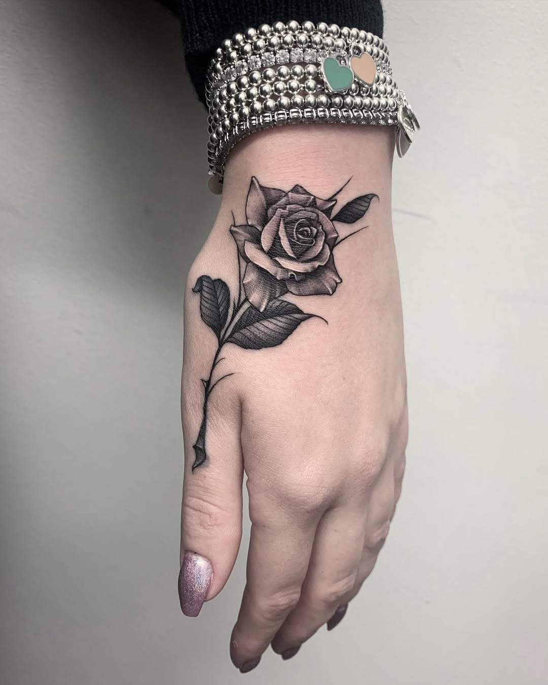 Stunning Black Ink Rose Tattoo on Hand