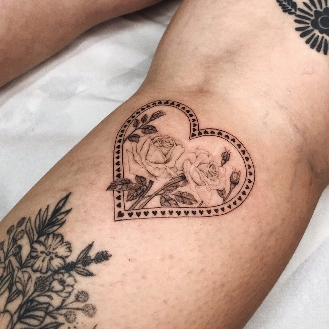 Heart-shaped rose tattoo with intricate details