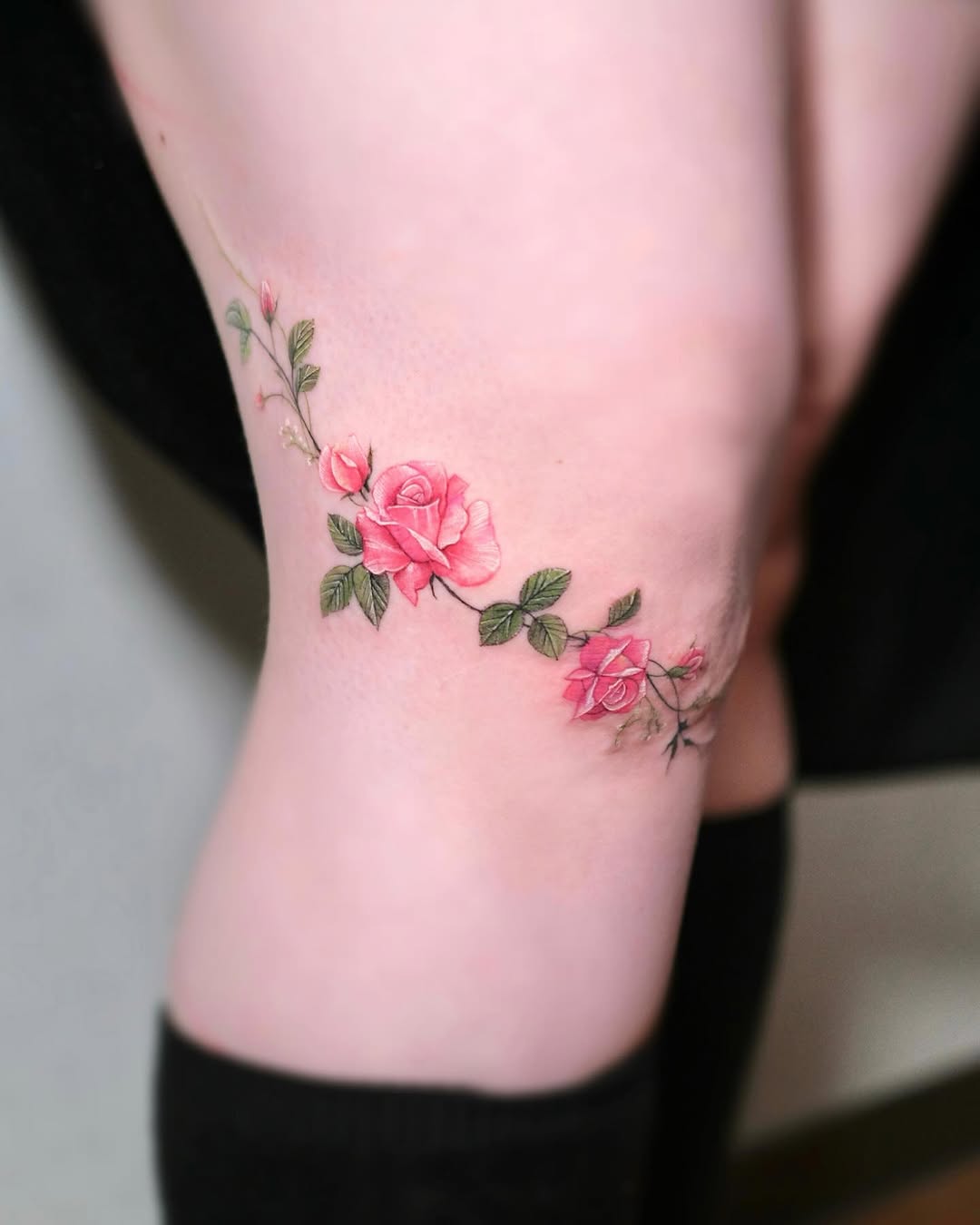 Elegant rose tattoo design on a knee