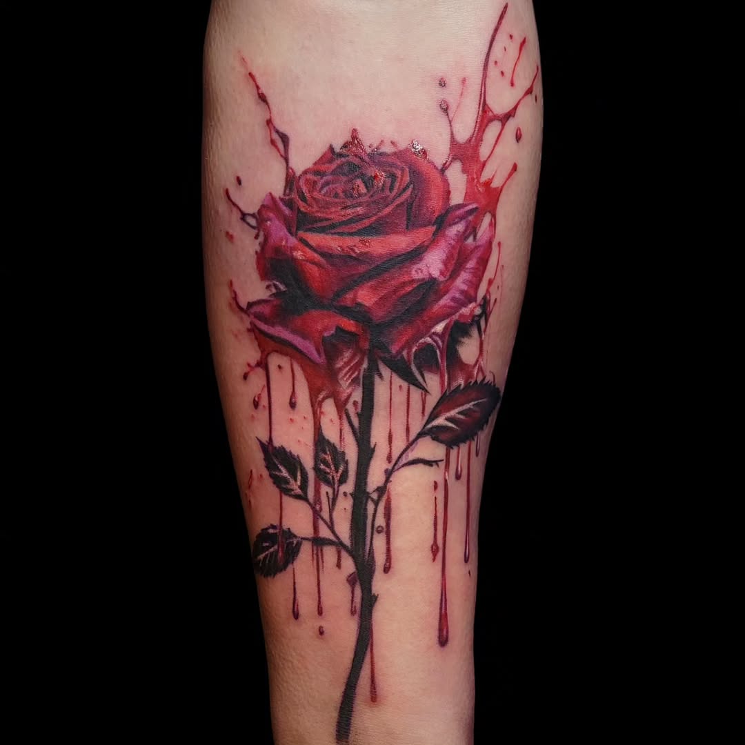 Dramatic red rose tattoo with splashes