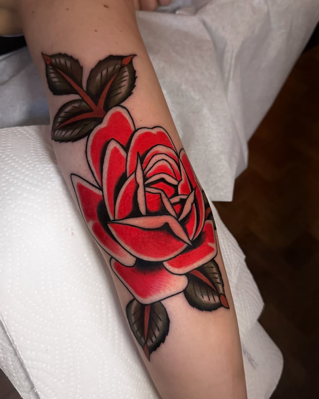 Stunning red rose tattoo on the forearm