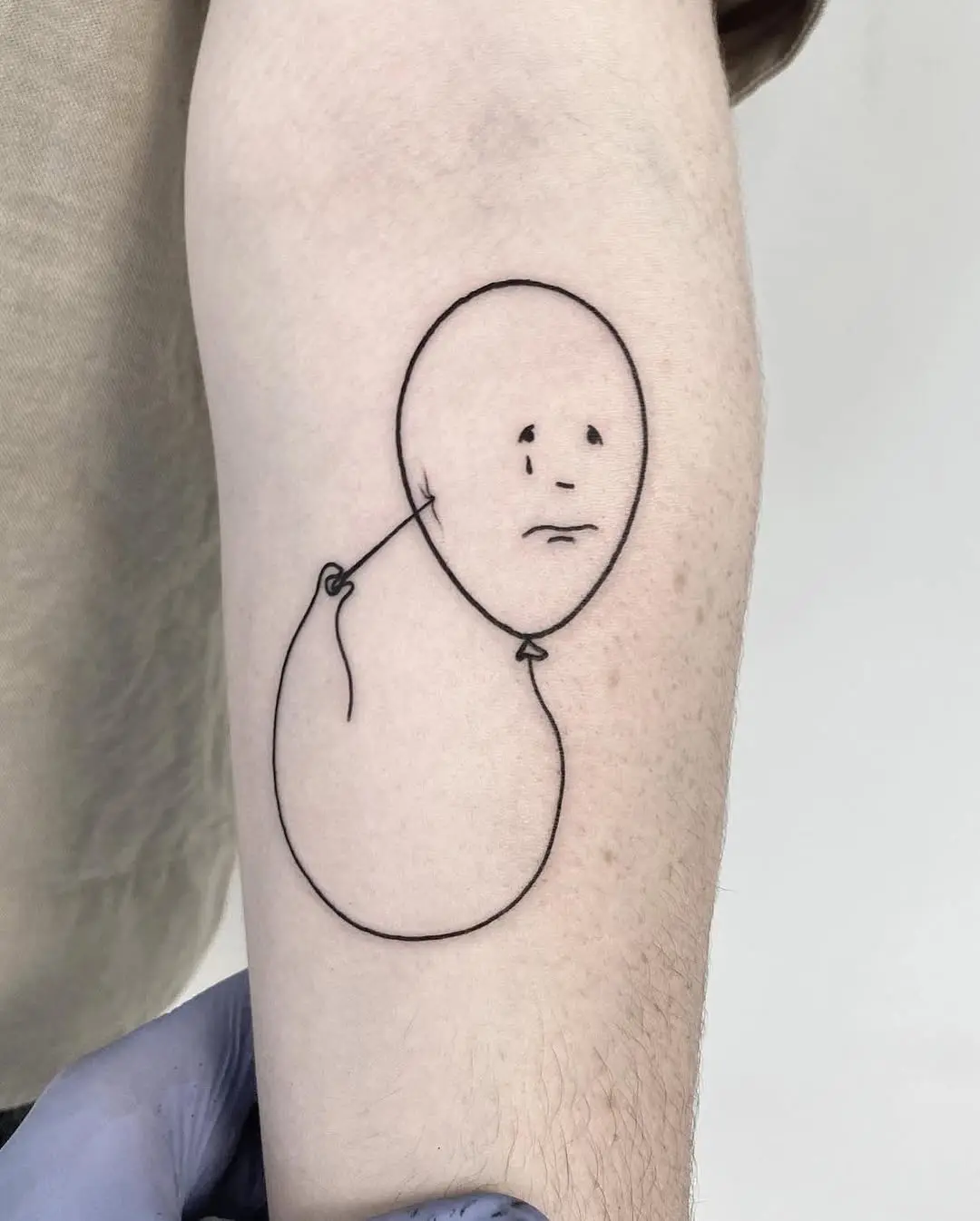 Minimalist tattoo reflecting deep, subtle sadness