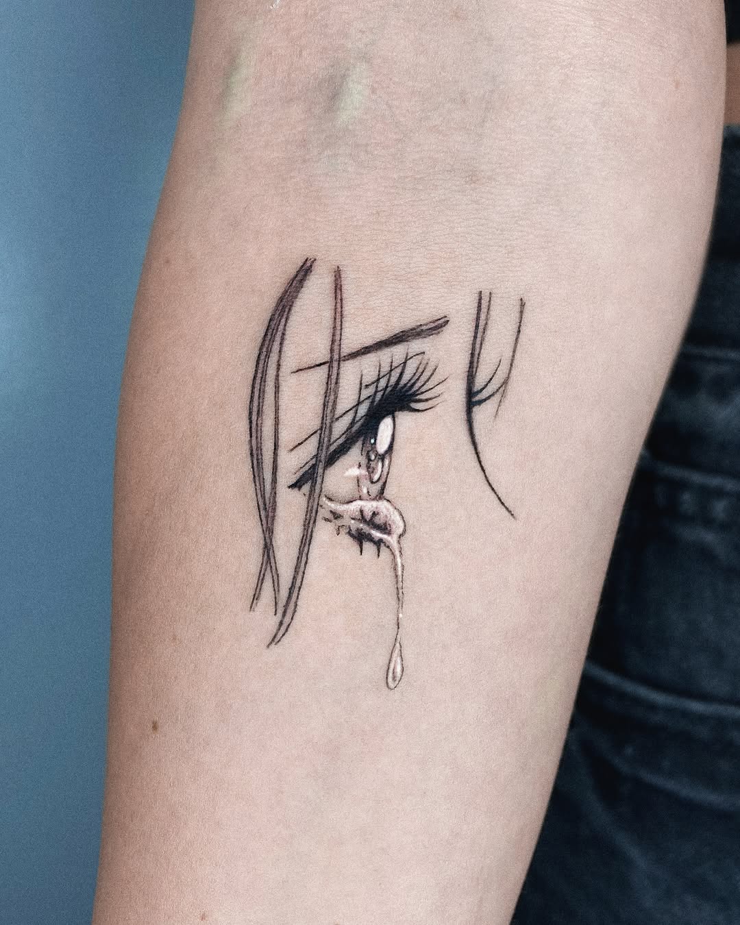 Expressive tear tattoo showcasing raw emotion