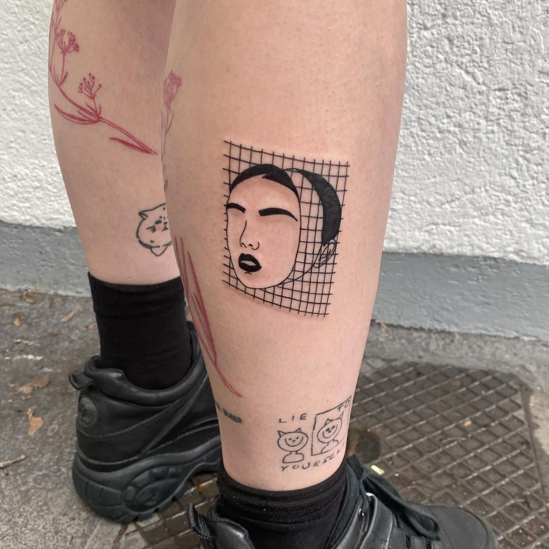 Emotional face tattoo with grid background