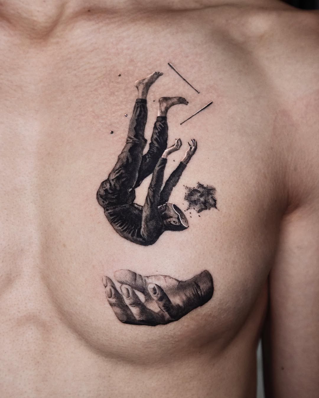 Falling figure tattoo with supporting hand motif