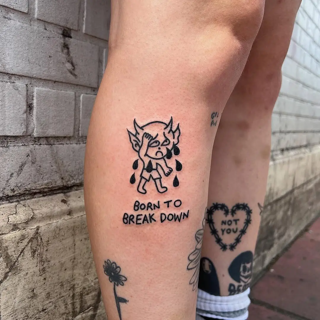 Whimsical tattoo of a tearful character