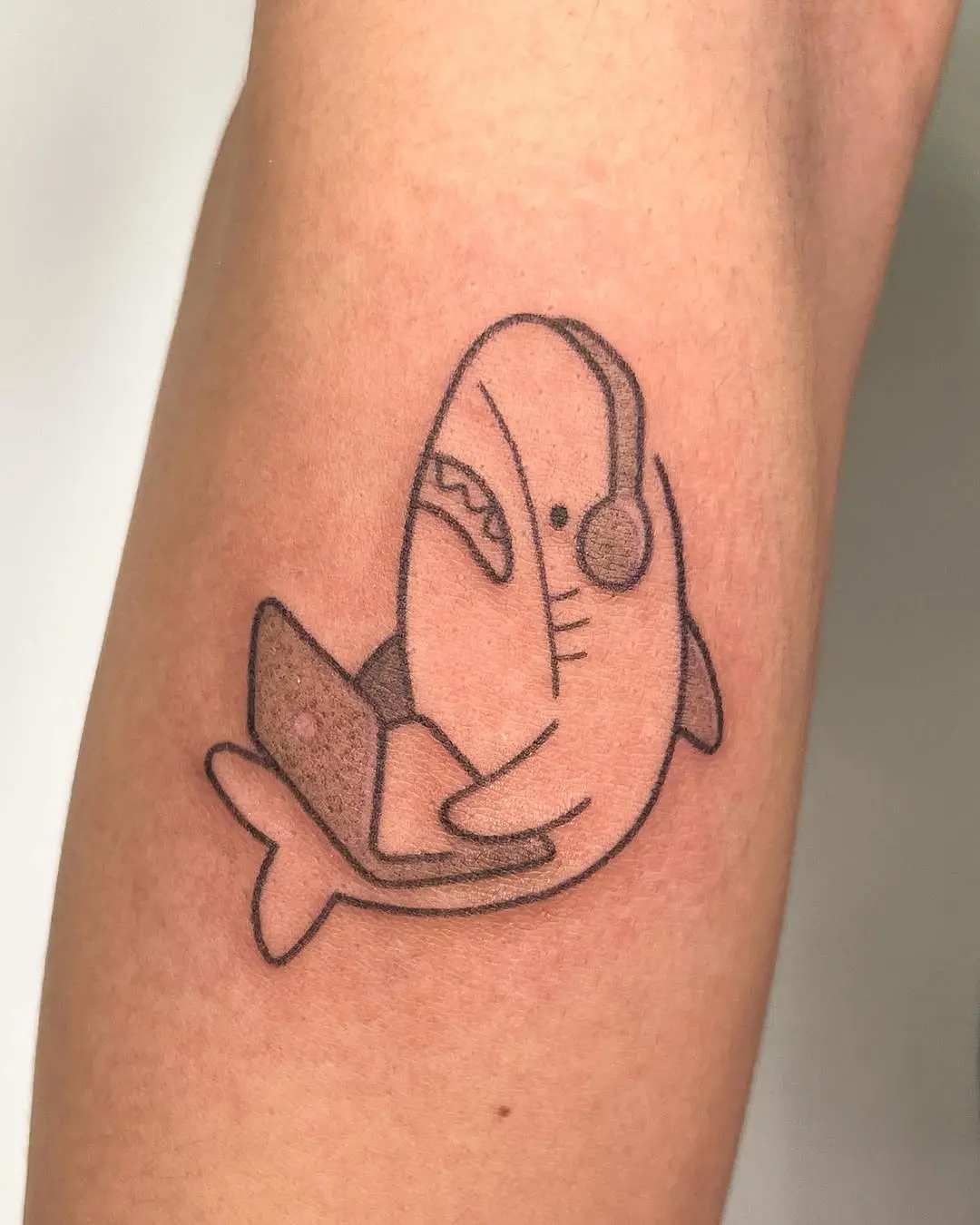 Whimsical shark tattoo with a modern twist