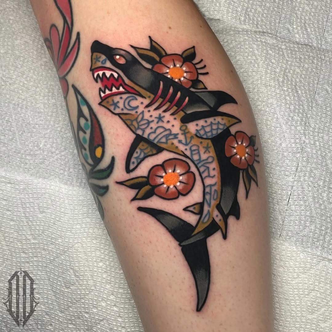 Vibrant shark tattoo adorned with floral elements