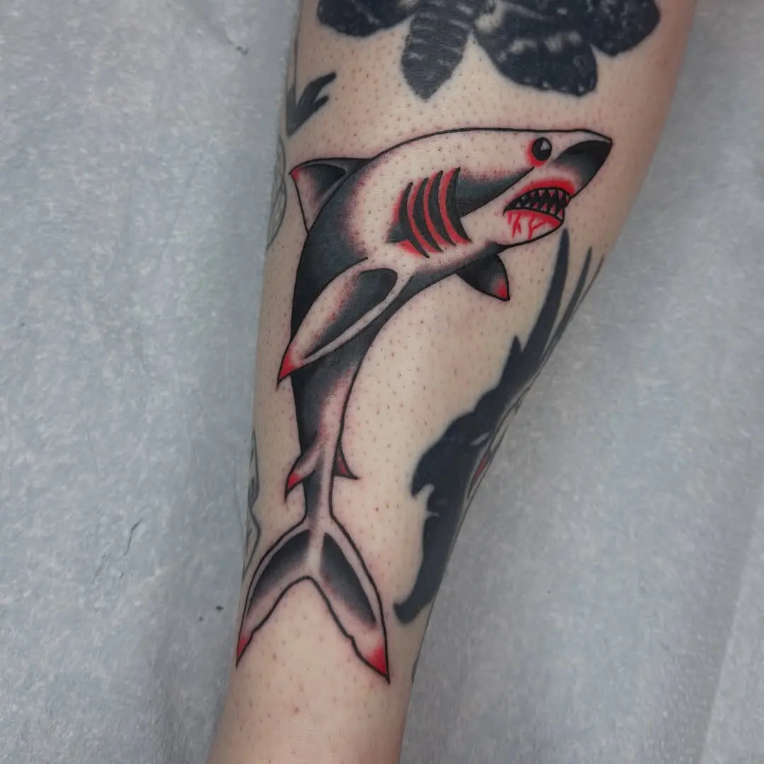 Bold shark design on forearm tattoo