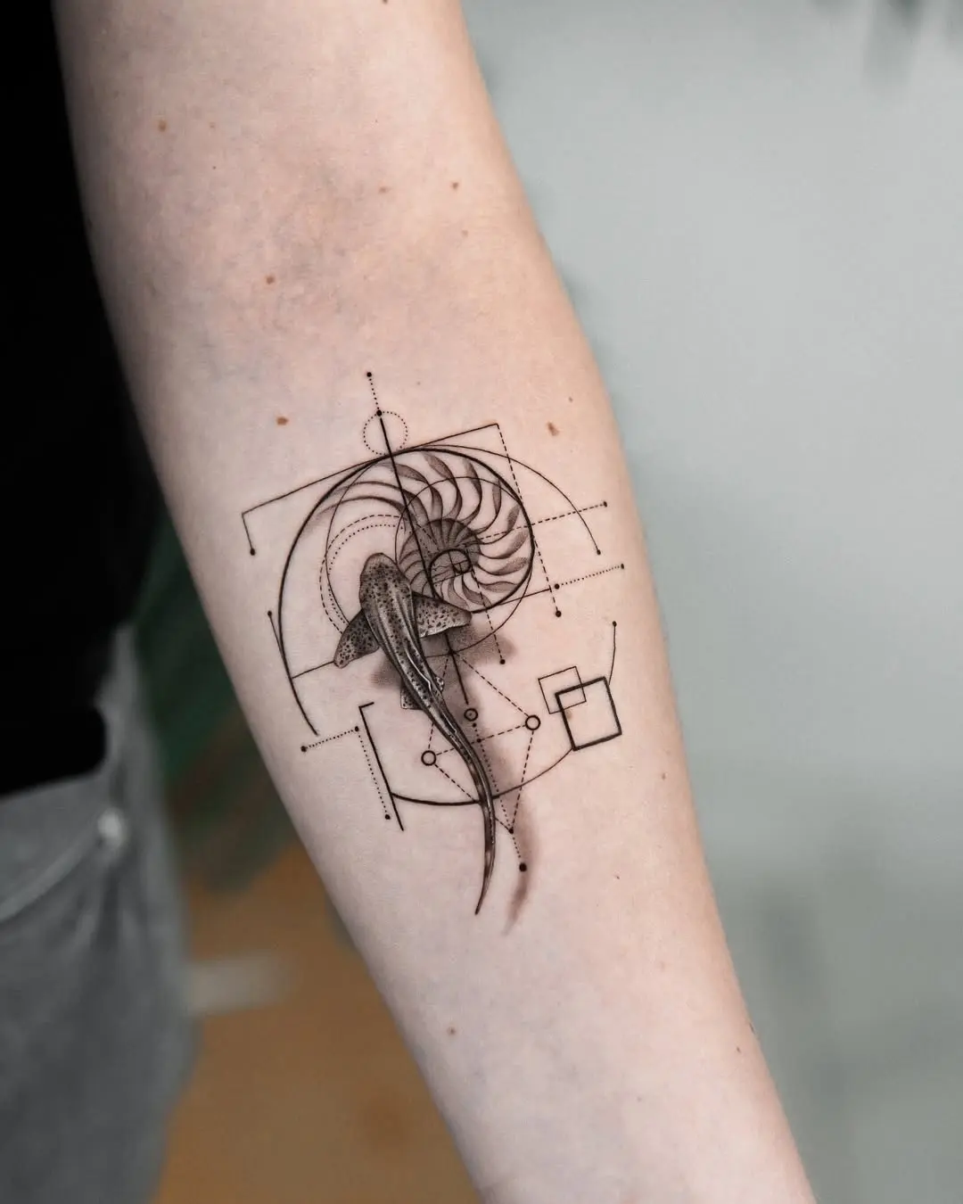 Stylish geometric shark tattoo on forearm