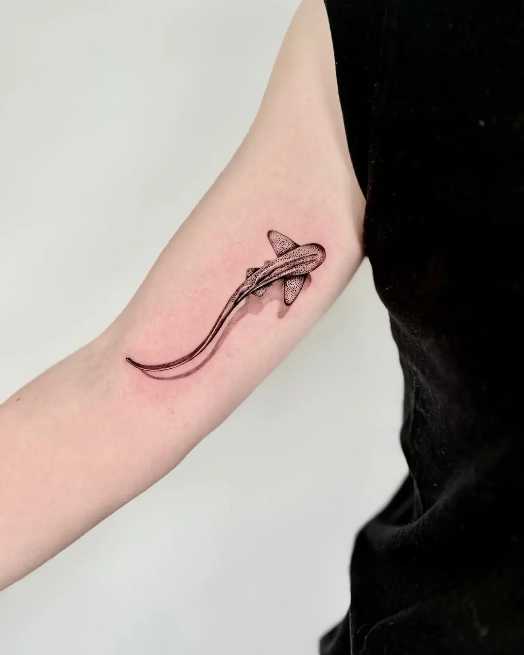 Minimalist shark tattoo in sleek monochrome style