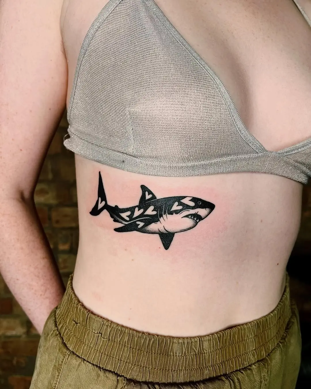 Stylish shark tattoo on rib area