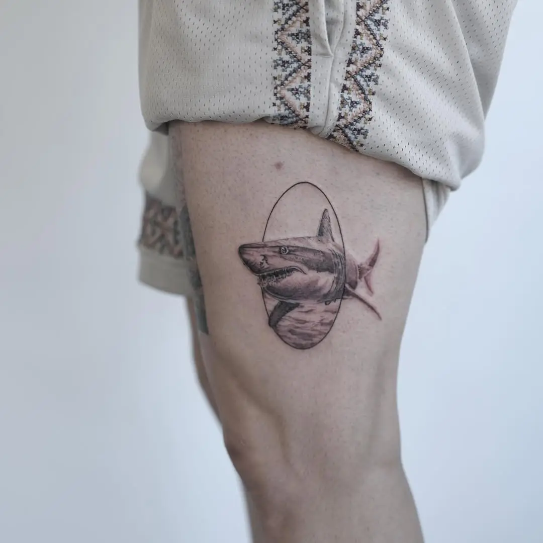 Detailed shark tattoo on thigh area