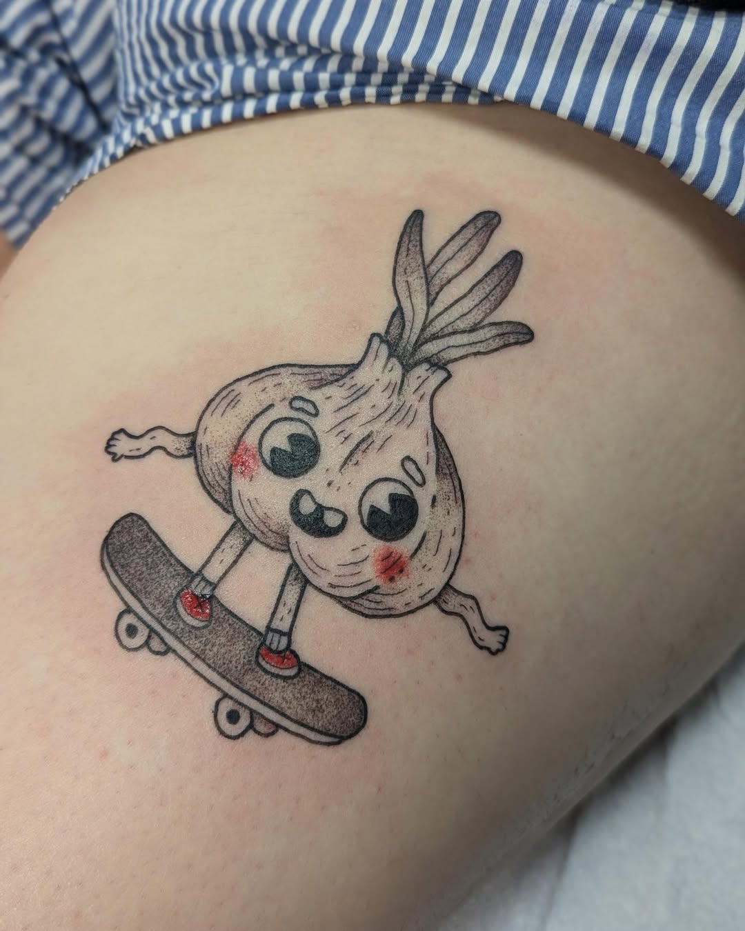 Whimsical Skateboarding Garlic Tattoo Design