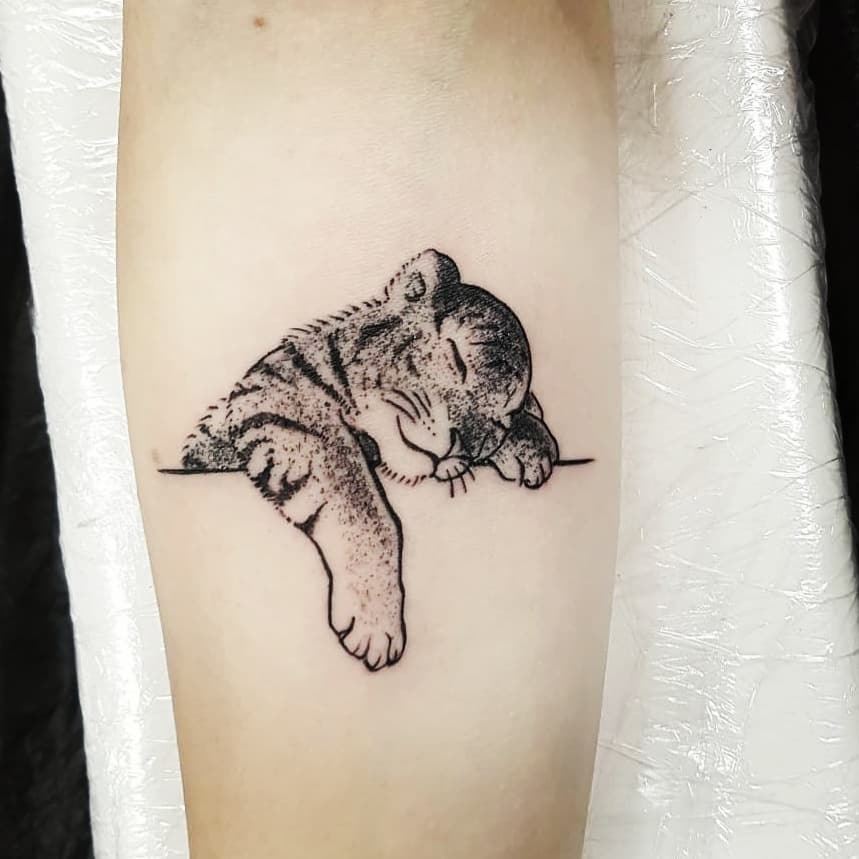 Charming sleeping tiger Leo tattoo design