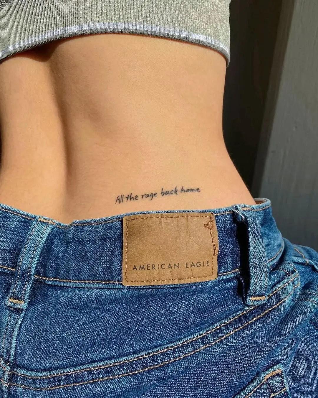 Stylish text tattoo on lower back