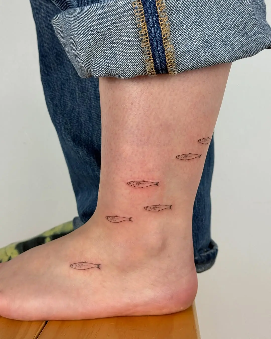Whimsical fish tattoos for delicate ankle art