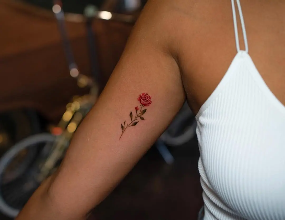 Delicate rose tattoo on a woman's arm