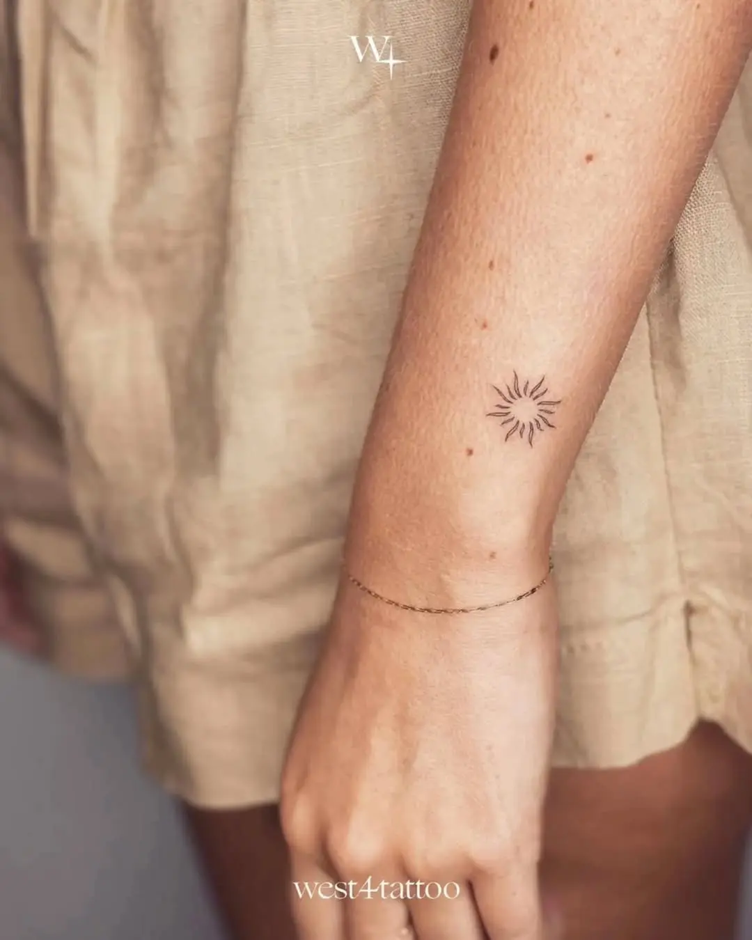 Delicate Sun Tattoo on Woman's Arm