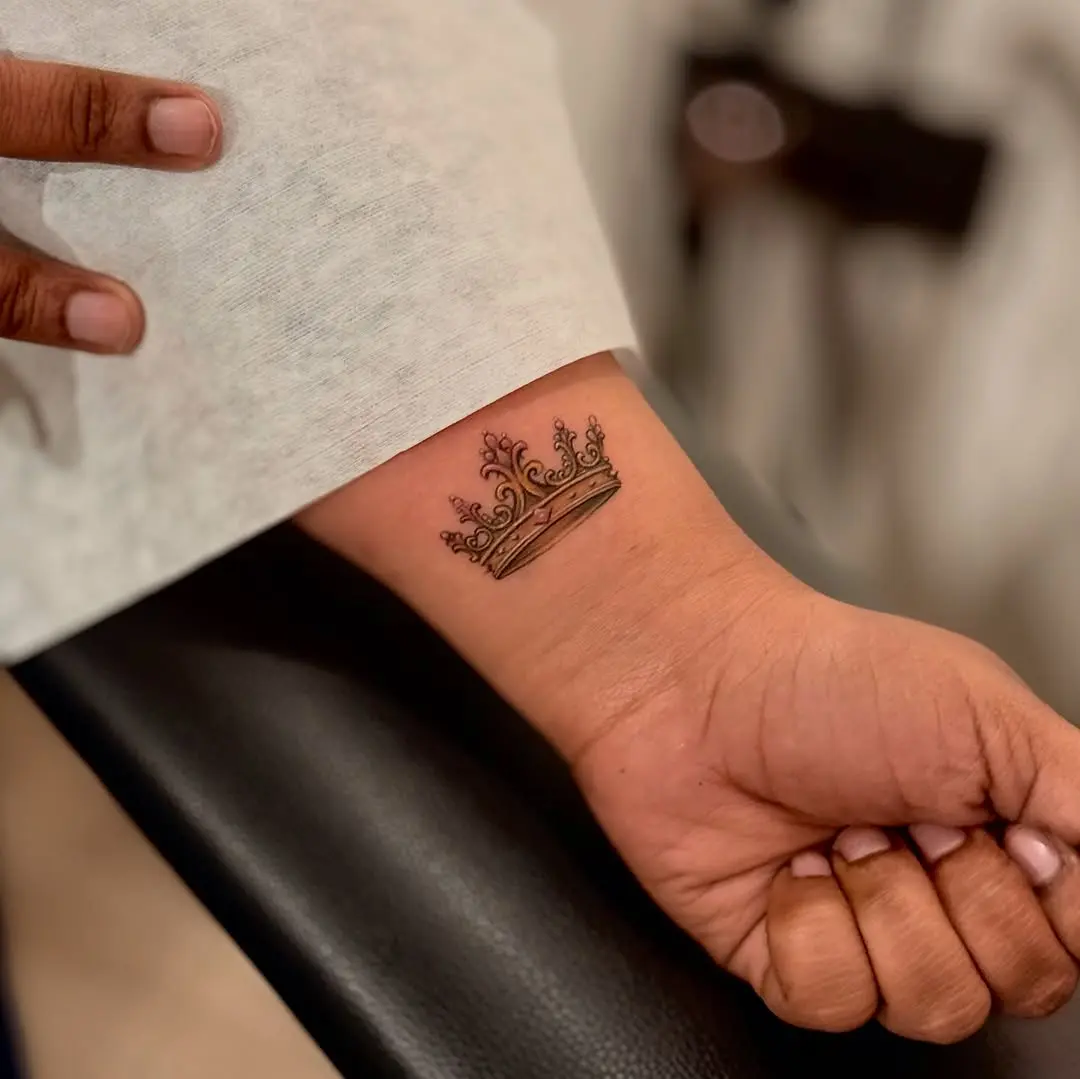 Elegant crown tattoo on wrist