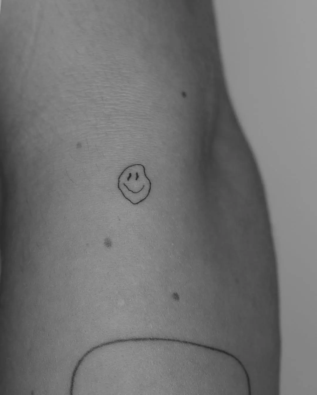 Charming minimalist smiley face tattoo