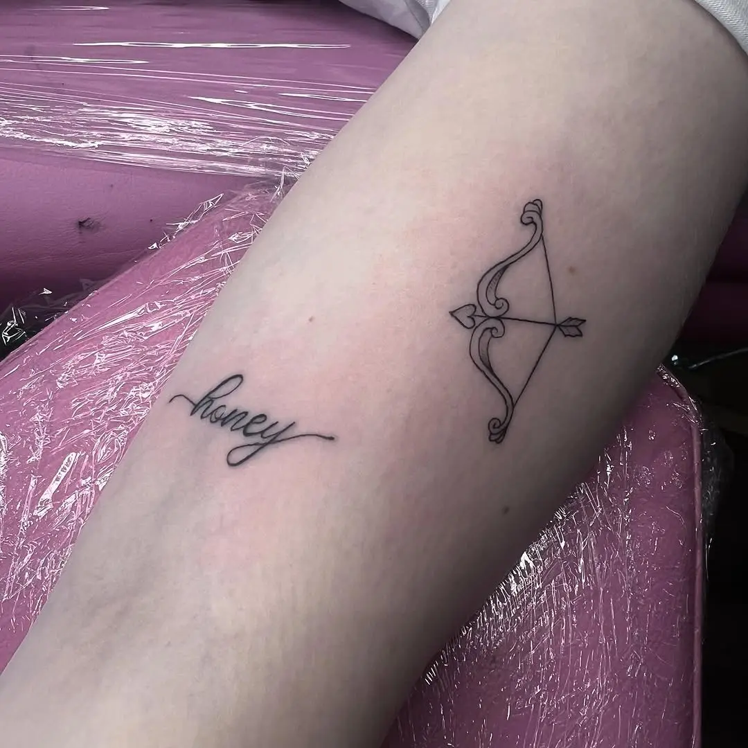 Elegant small tattoo combining words and symbols