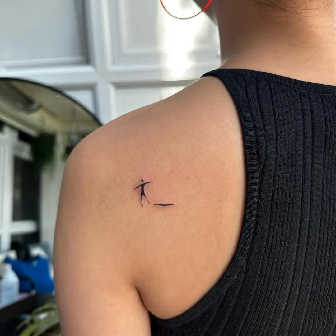 Elegant small tattoo on upper back