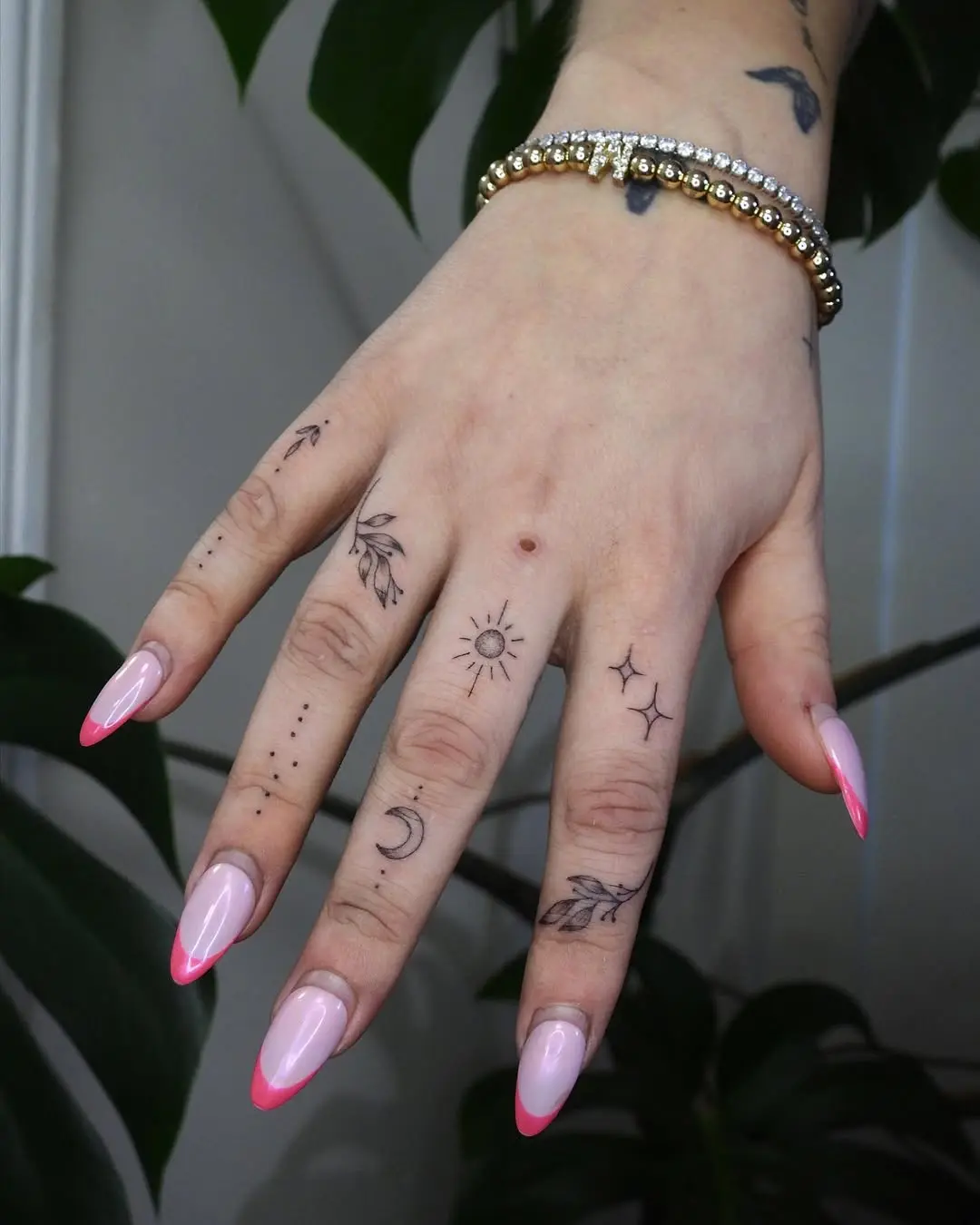 Charming small tattoos adorning a graceful hand